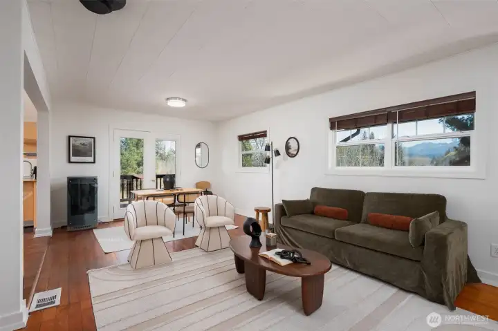 Mountain views as you move through your living room. There is a propane heater there in the living room to keep things toasty in addition to a furnace for heating the home. Owners used this propane heater the most.