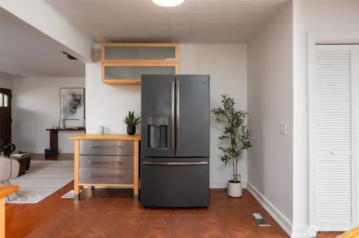Full size refrigerator and you can fit a stackable laundry in this space. Hook up is behind fridge.