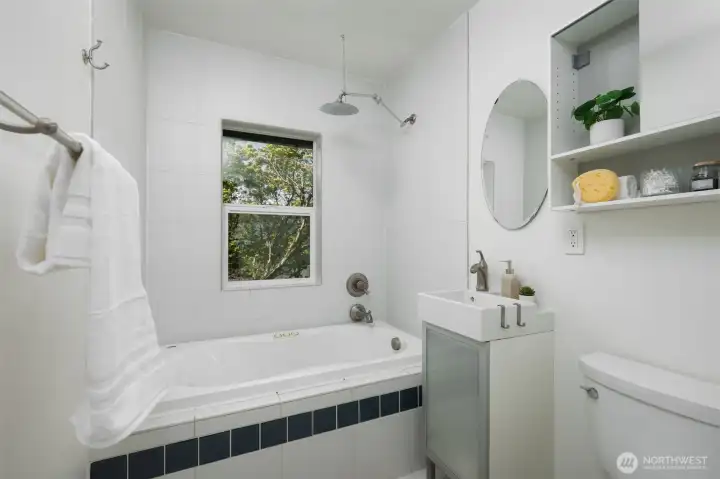 Bathroom complete with soaking jetted tub.