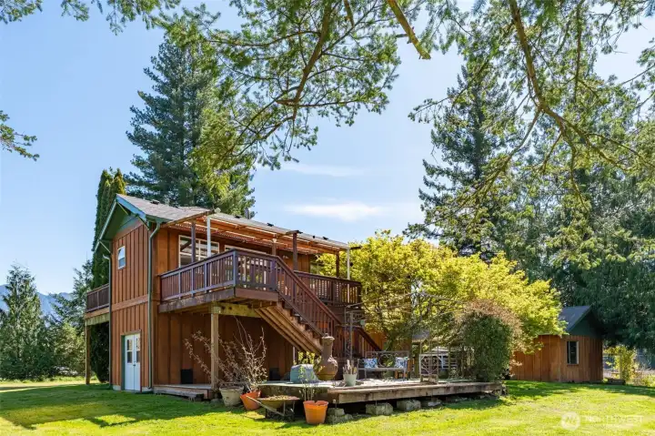Full back view of home and decks and side entry to basement.