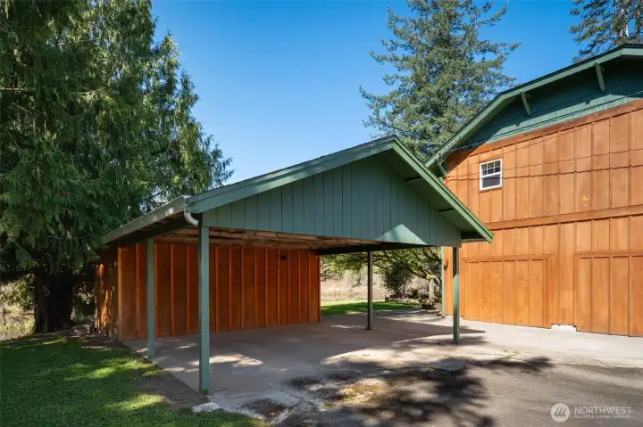 2 Car carport to keep your vehicles dry. At back of carport is another shed for storing anything you need.