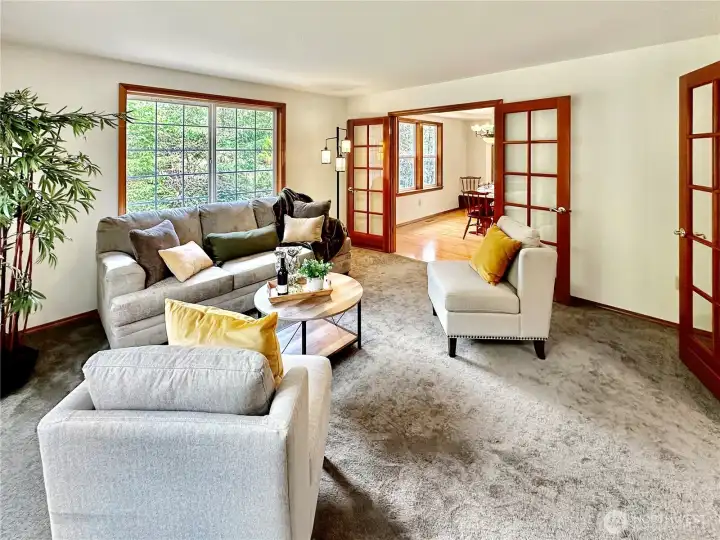 Another view of the living room...the French doors make it nice for additional privacy from other actives.  Notice the beautiful wood wrapped windows, doors and baseboard.