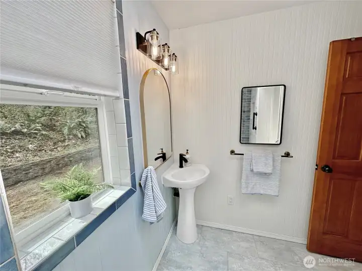 Another view of the guest bath with corner pedestal sink.