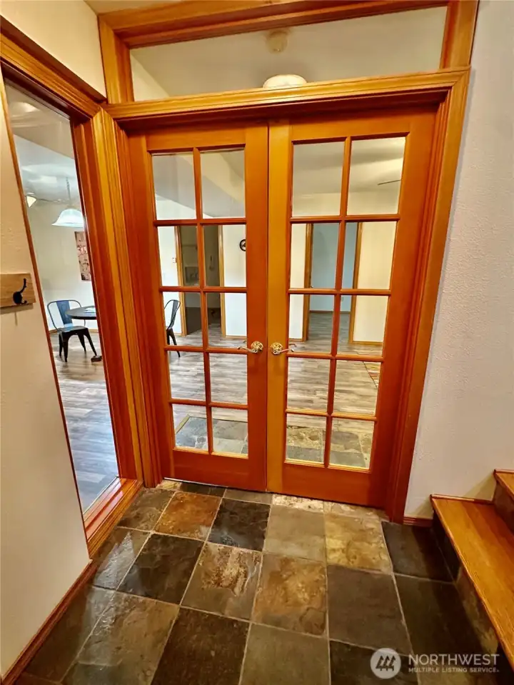 Rec room access with slate floor and French doors.  The garage door access is on the opposite wall of this entrance.