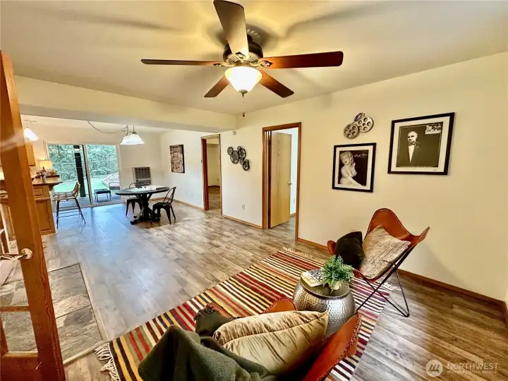 Large rec room on the lower level...the current owner had a pool table where the staging table is located offering easy access to the wet bar and slider to the rear covered patio.