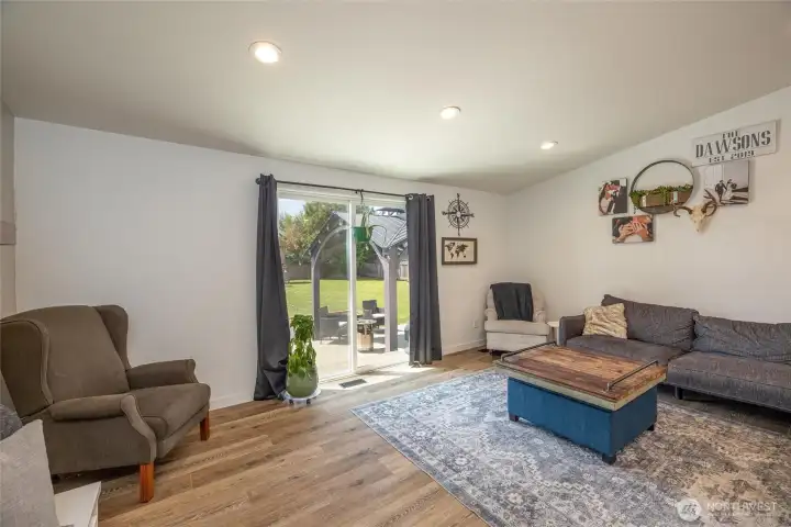 living space with doors to backyard