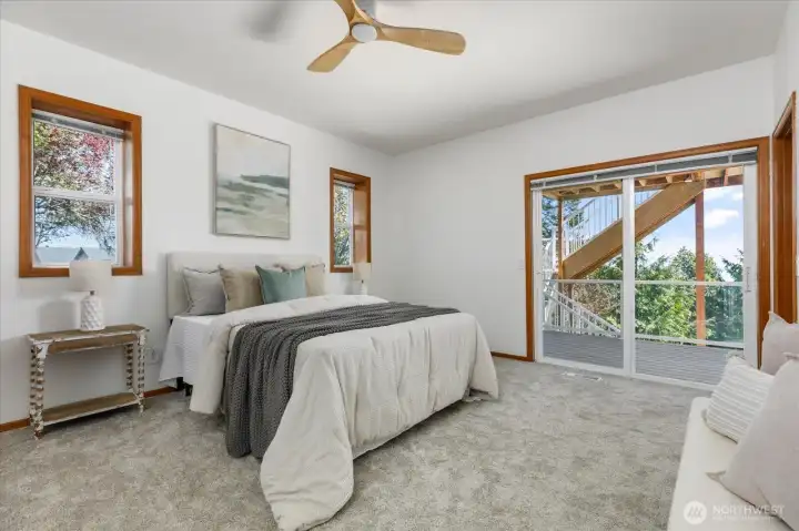Primary bedroom has spacious walk-in closet and slider to the lower view deck