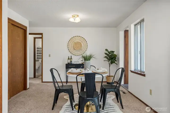 The dining room connects seamlessly to both the hallway and living room, enhancing the home's functionality.