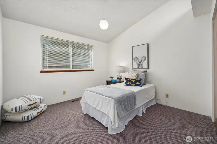 Vaulted ceiling enhances the spacious feel of the third bedroom.