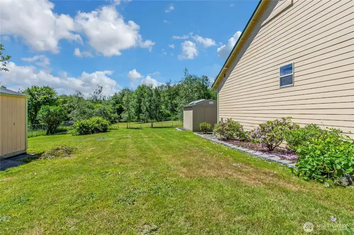 Side yard with showing both sheds