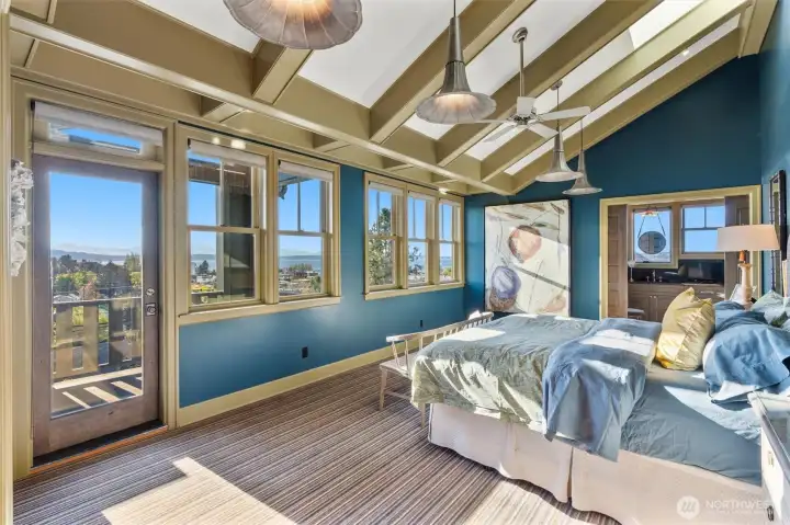 Designed as a private sanctuary, the owner's suite features vaulted ceilings, skylights, designer lighting, a secluded view deck, and a spa-caliber bath worthy of a five-star resort. Expansive views of the Sound and mountains stretch across three directions, immersing the space in natural beauty. Complementing the suite is an inviting sitting area, offering a peaceful retreat for morning reflection, evening relaxation, or simply taking in the remarkable scenery.