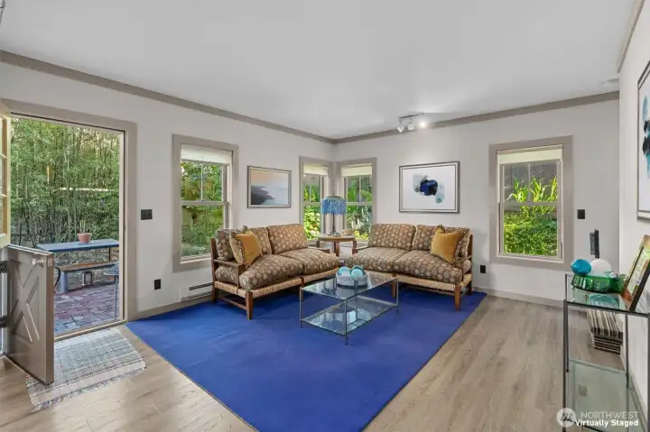 Living room in the ADU featuring a Dutch-door that opens to the private brick patio.