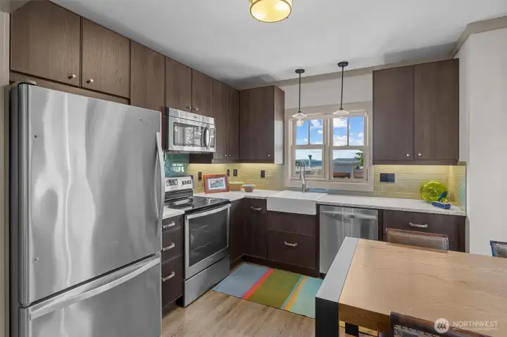 The kitchen in the ADU has stainless steel appliances and French doors that open to a private patio - there's even a great view of the Sound.
