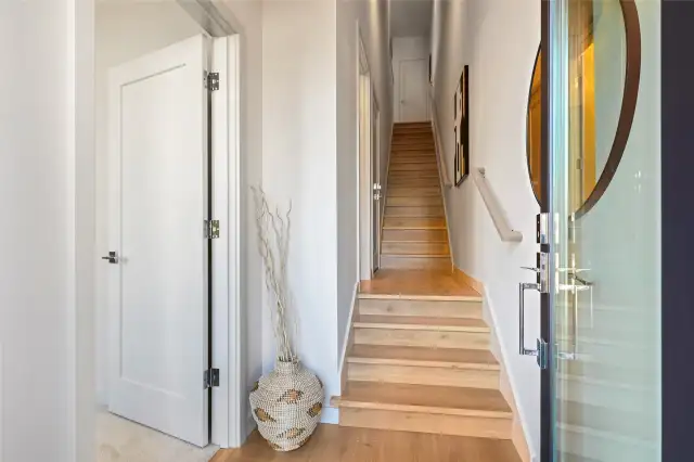 Step inside and feel the difference — this inviting entryway sets the tone with warm wood floors, clean lines, and simple elegance.