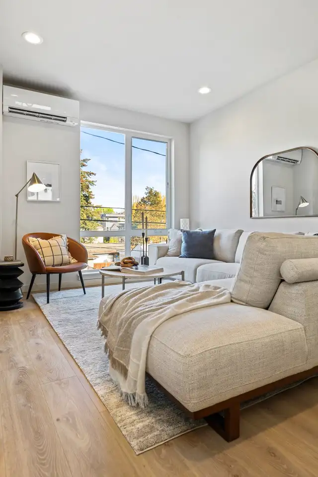 Tucked just off the kitchen, this living space is ideal for lounging, morning coffee, or a good book with sunlight pouring in.