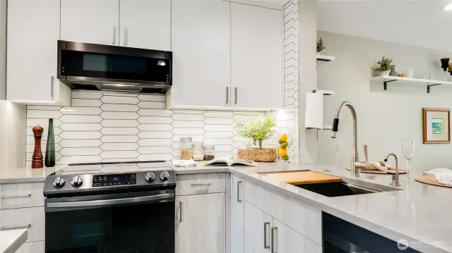 Kitchen with custom cabinets including under cabinet lighting