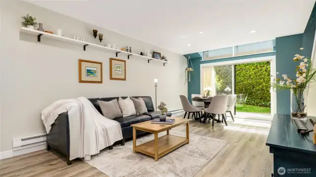 Bright and spacious living room with eating space and large slider to let in natural light