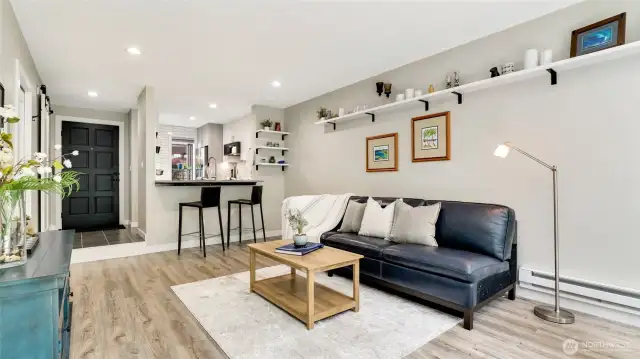 Living room with built-in shelving. Efficient baseboard heaters with Smart programable thermostat.