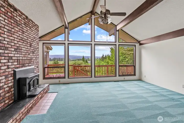 This is what you walk into - check the VIEWS!!! Beamed, vaulted ceilings, wood burning insert, carpet just professionally cleaned.