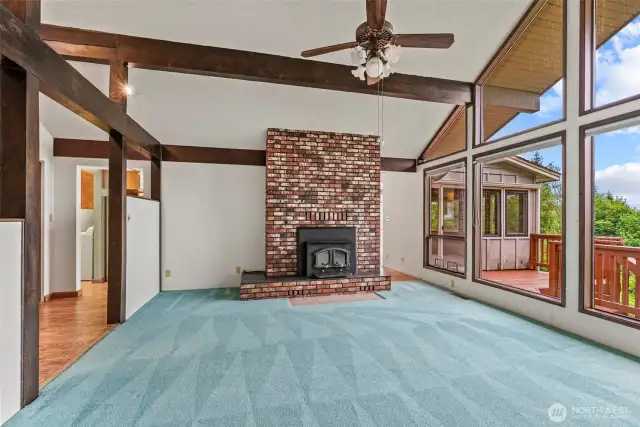 Fireplace and deck view - beams and windows galore!