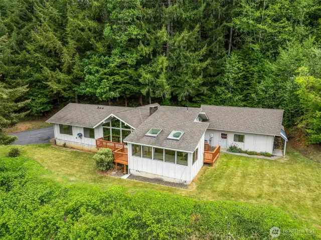 Newer roof, freshly painted decks, asphalt driveway and parking apron.