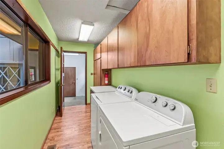 Large laundry with built-in storage, walk through back porch for quick access to garage, additional guest area & back yard.
