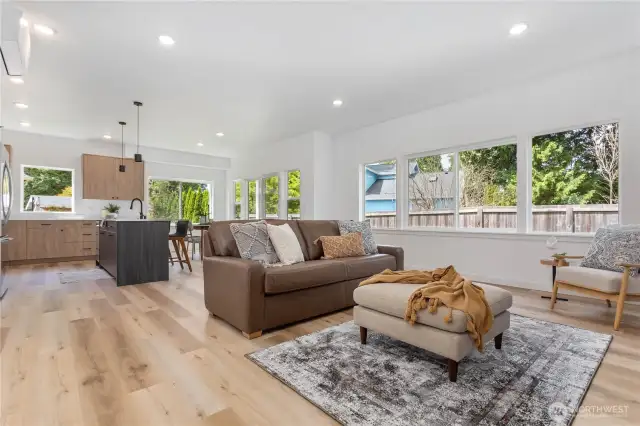 Great room showing sitting, and eating areas and access to patio and rear yard.