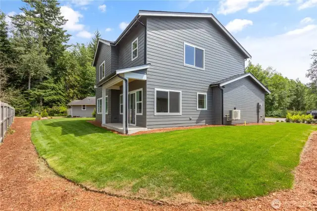 Left side of  home showing outdoor part of ductless heat pump system.