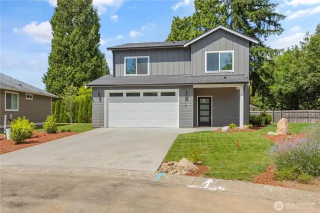 Front of home with parking in front of garage.