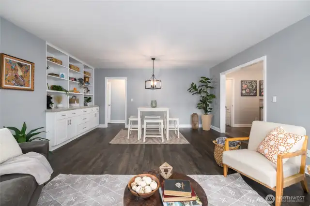 Living and dining area.  Kitchen to the right.  Door at the back leads to the hallway and bedrooms.