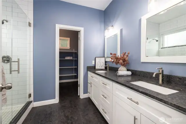 Primary ensuite bath and walk-in-closet.  Double vanity with leathered granite countertop and backsplash, lots of storage (soft close doors and drawers).  Step-in tiled shower with glass enclosure.  WIC has lots of shelving and even room for your dresser in the closet!