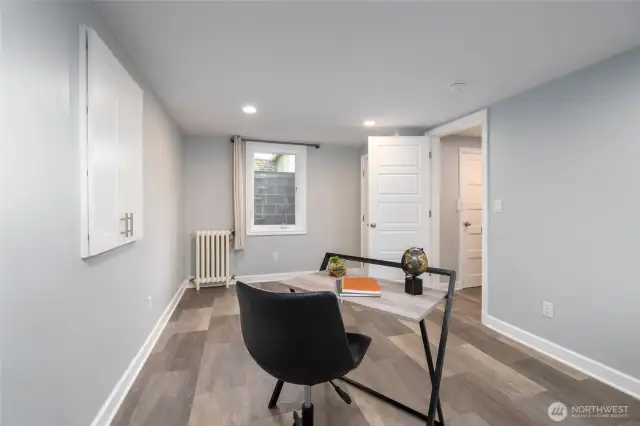 In the fully-finished basement, a 4th bedroom can also be used as a home office.  Lots of natural light through the oversized window.