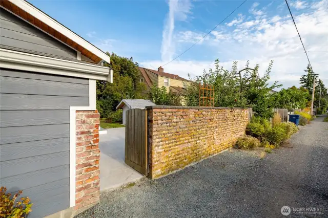 How charming is this??  Your own brick walled garden and patio area, with an adorable gate to the adjoining alley.