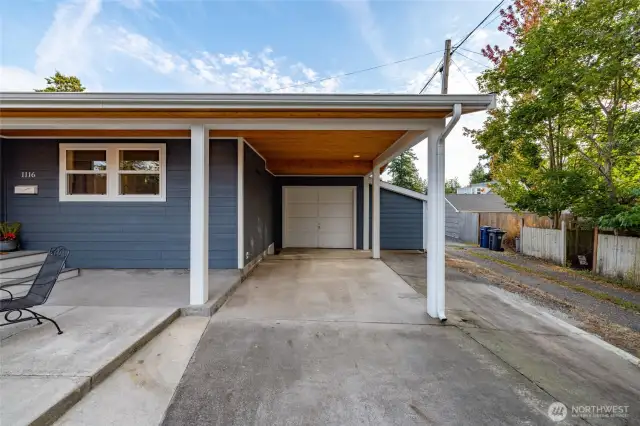 Attached garage and carport.  The siding to the right of garage is a huge storage shed accessible from the back patio.