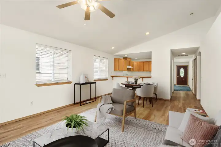 Large family room with space for eat at bar or dining table- vaulted ceilings and fresh paint