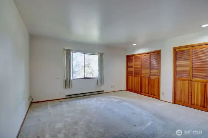 Primary bedroom with double closets.
