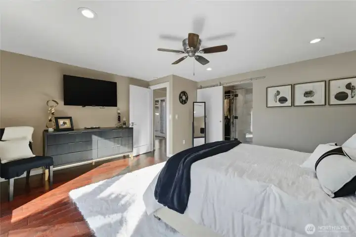 Primary bedroom - bed facing tv mounted on wall