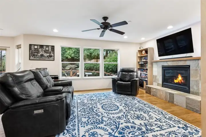 Living room with cozy gas fireplace with tiled mantel, (TV is included)
