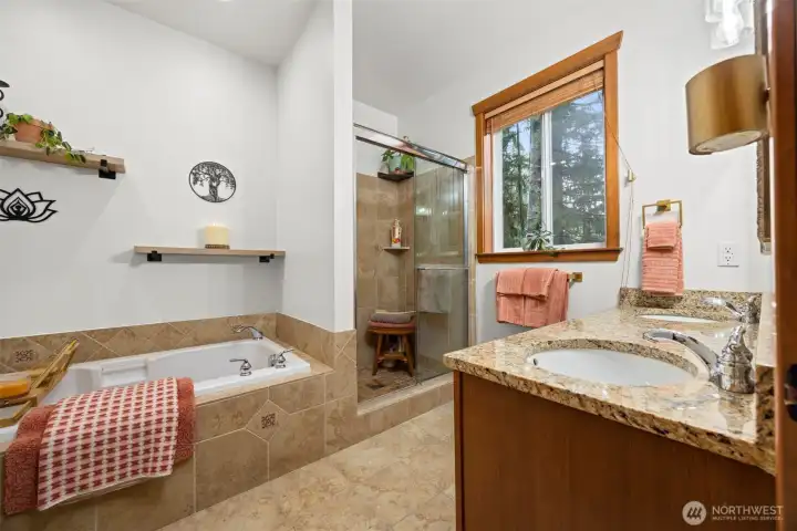 Ensuite bath with soaking tub, shower, pretty tile.