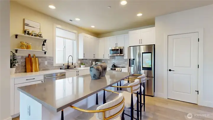 Kitchen. Door opens to a pantry.  Image 2 of 2.