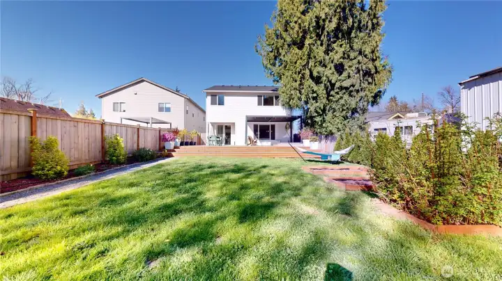 Backyard has something for everyone - fruit trees, raspberries, garden boxes, grass to play on, take a nap in the hammock, party on the deck, or relax in the hot tub.