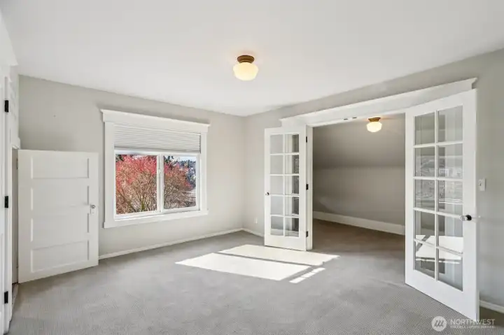 West facing bedroom with additional space - what you see beyond French doors is NOT the closet but could be if you wanted.