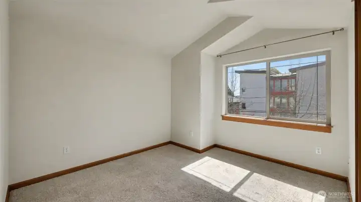 Primary suite with vaulted ceilings, walk-in closet and seating nook.