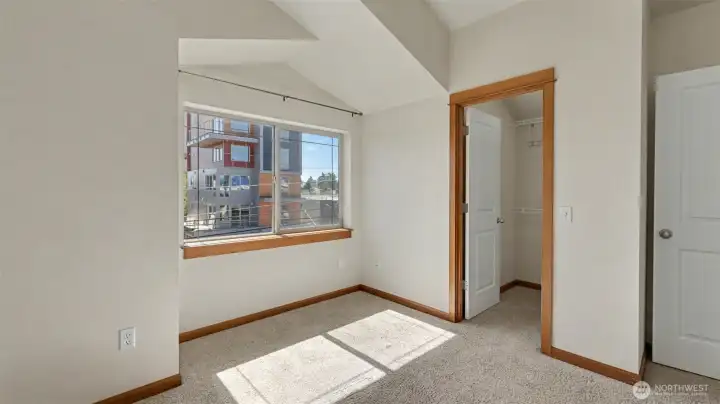 Primary suite with vaulted ceilings, walk-in closet and seating nook.