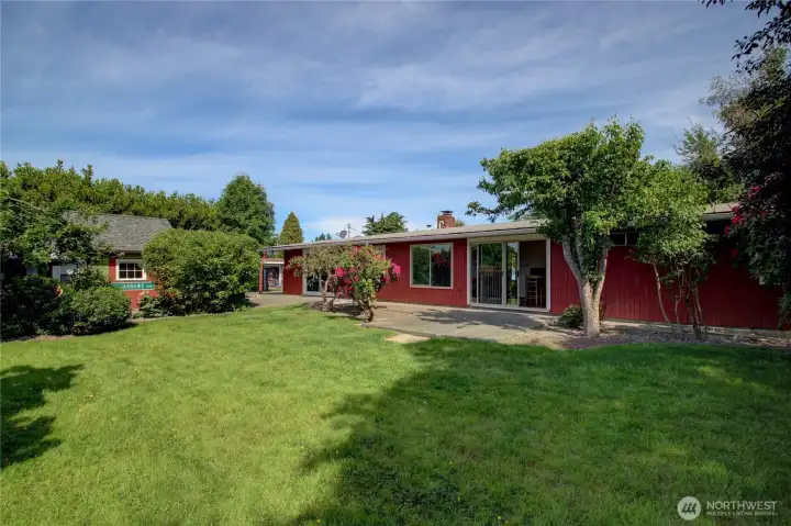 This fenced back yard has both ample lawn and patio space.