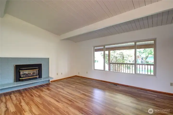 The front living room (along with the rest of the home) has been freshly painted and has oversized windows throughout.