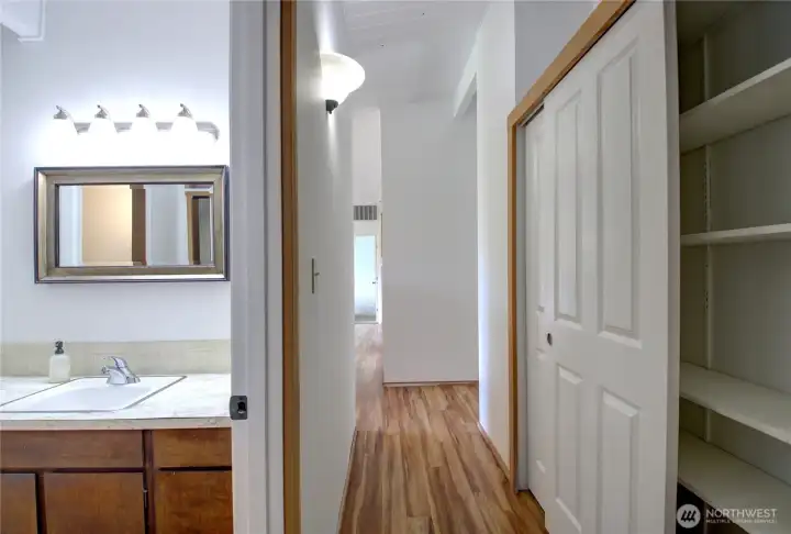 This is the shared bathroom. Large double door pantry on the right.