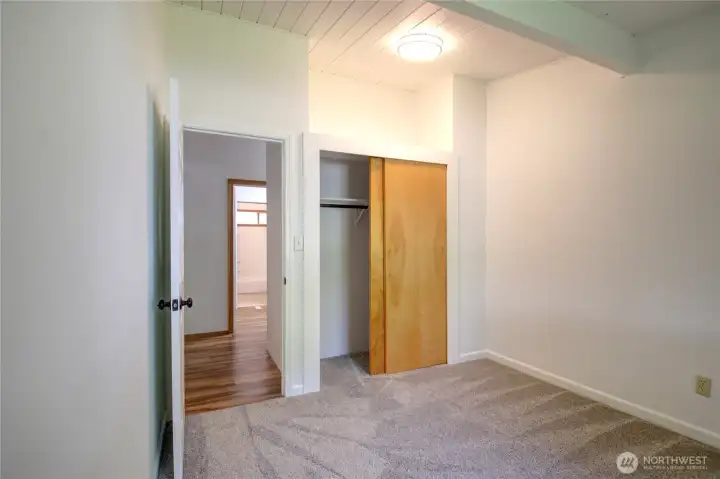 The third bedroom with a view of the bathroom across the hall.
