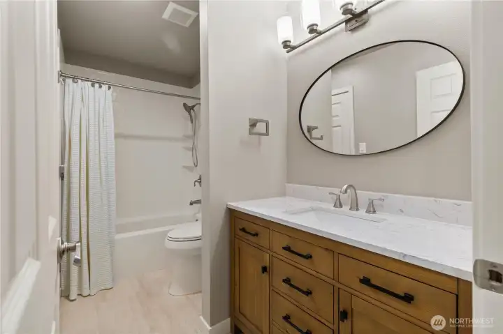 Guest bath with new vanity, sink, mirror and lighting. There is a second entrance from the guest bedroom. Guest bath with new vanity, sink, mirror and lighting. There is a second entrance from the guest bedroom.