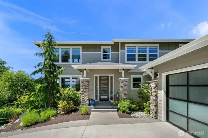 A welcoming, covered entry and attached 2 car garage